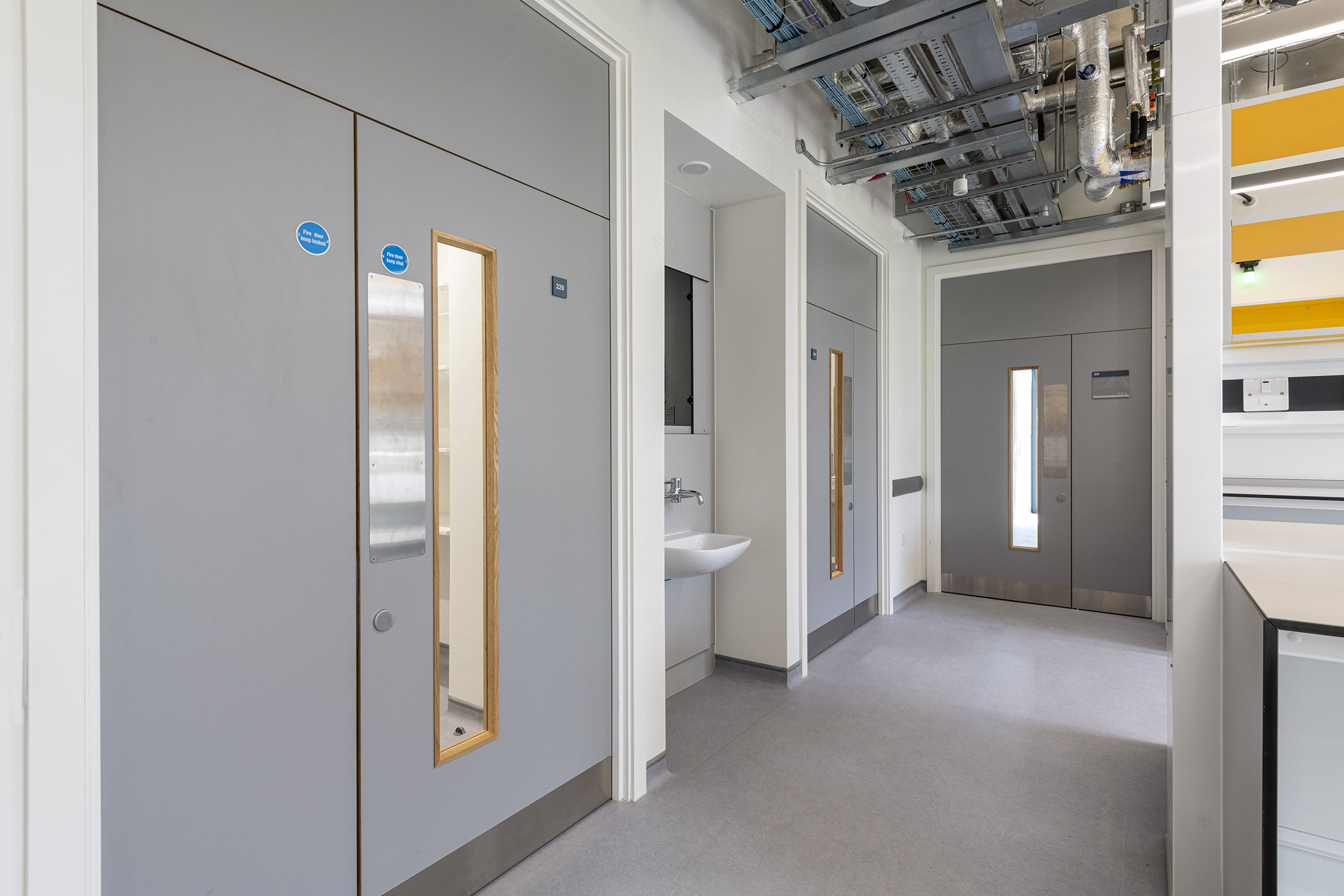 Grey fire doors with vision panels at the Pears Building